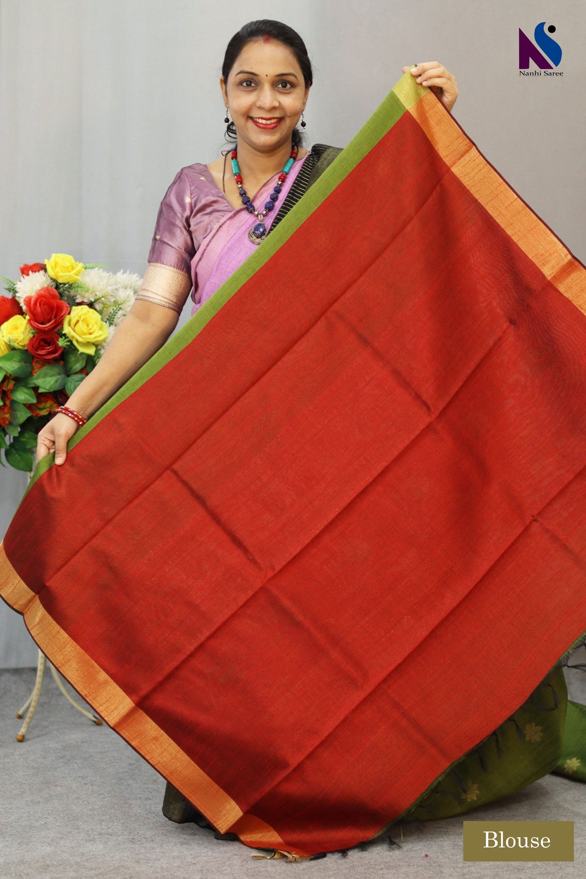 Earthy mehendi and rich red tones paired with elegant handloom craftsmanship saree