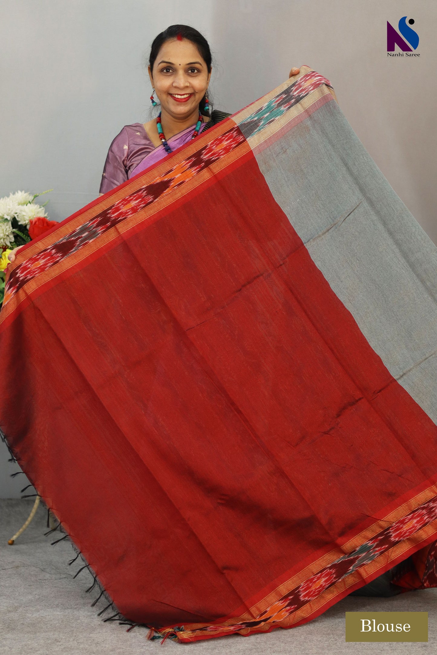 Traditional Pochampally design highlighted on this elegant grey handloom saree