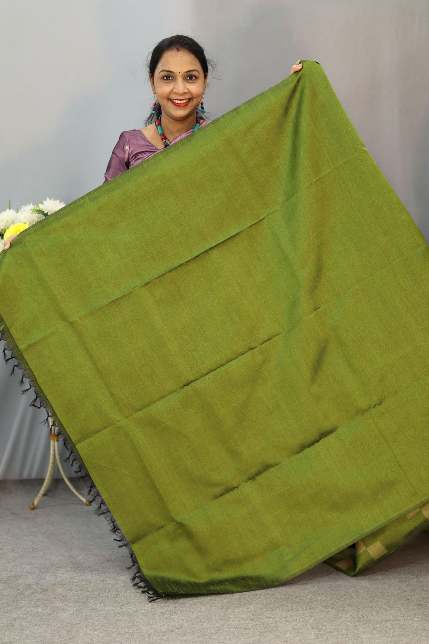 "Graceful mehendi green hand-woven saree, woven with elegance."
