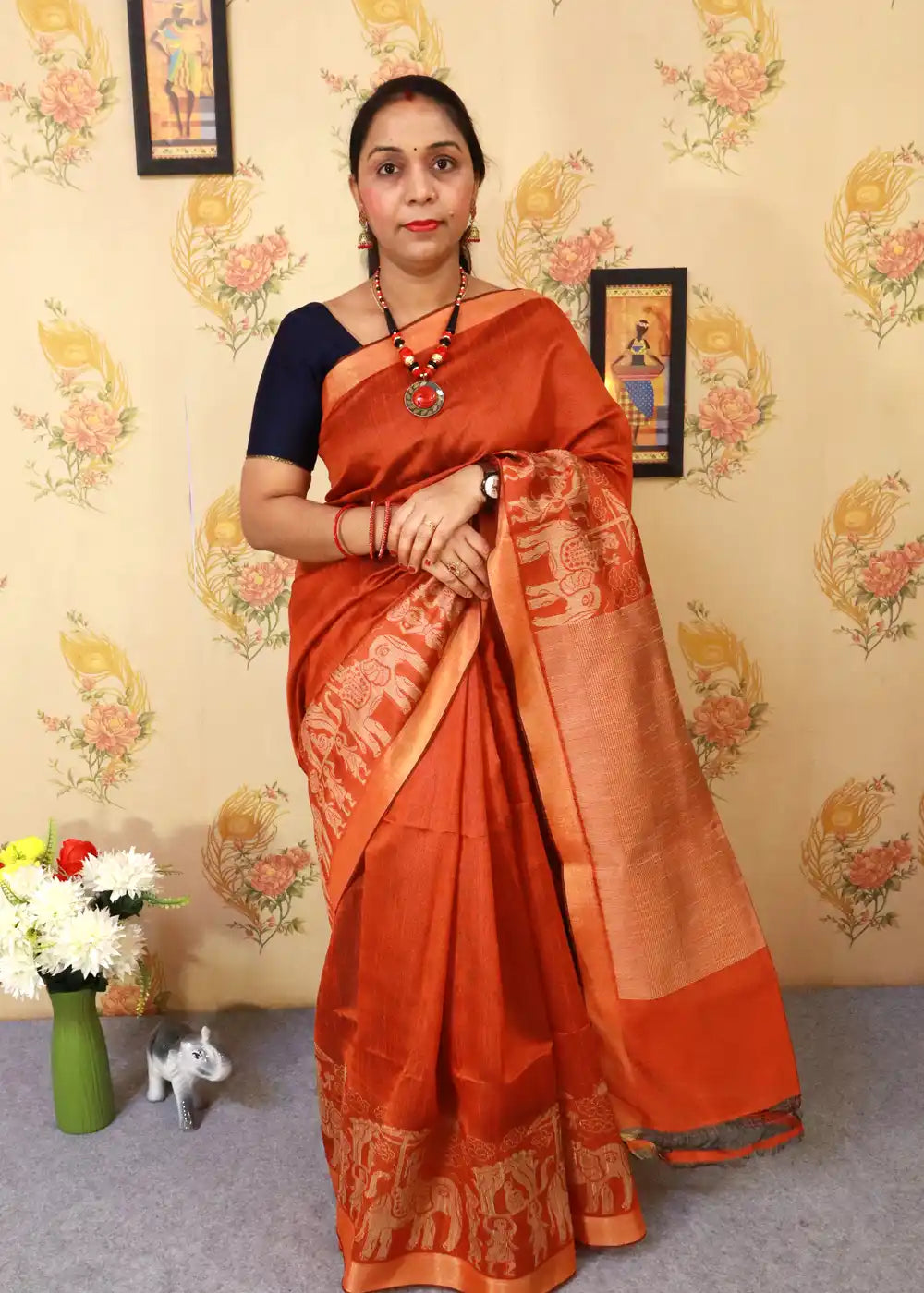 "Elegant rust orange art silk saree with timeless pallu design."