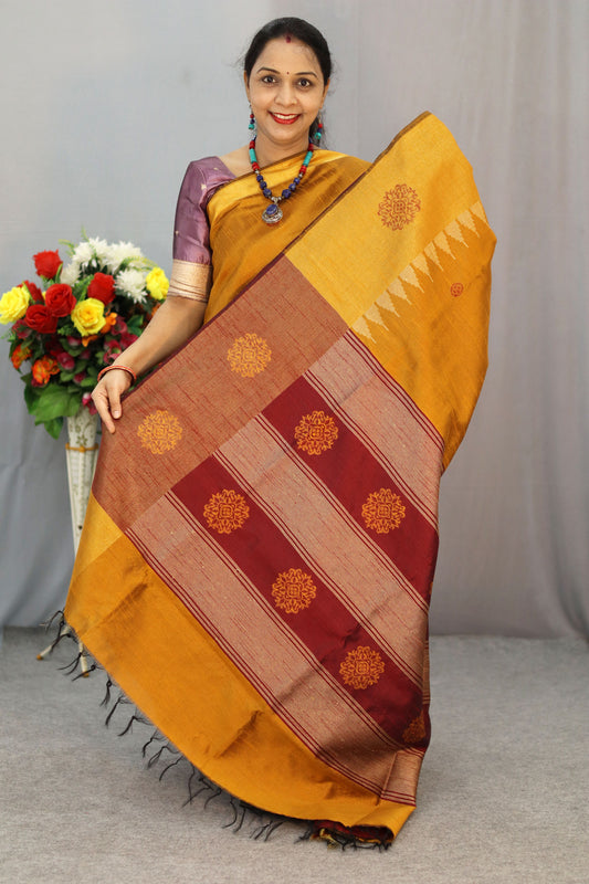 "Elegant orange and turmeric yellow hand-woven saree, crafted beautifully."