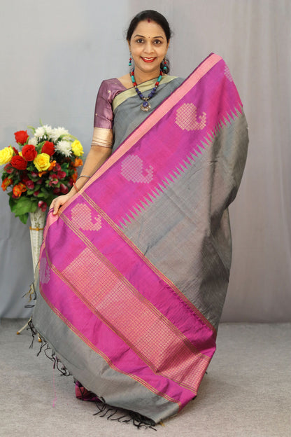 Handwoven gray art silk saree with soft yet striking pink pallu