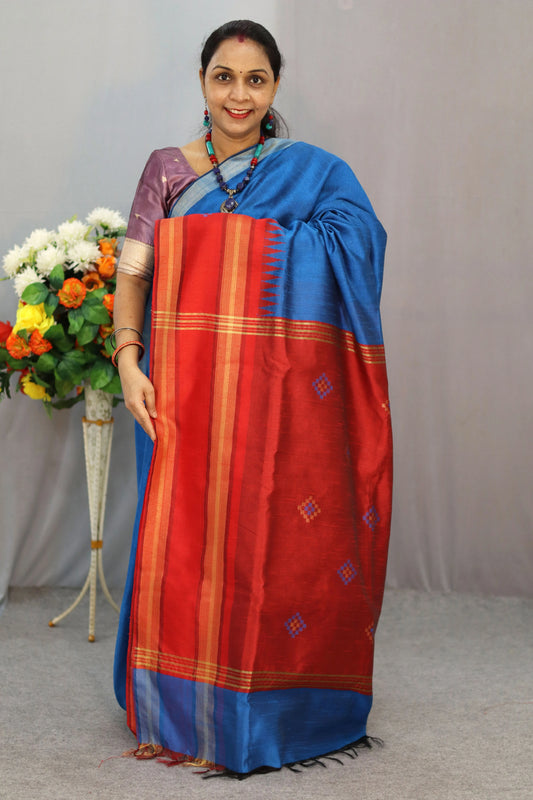 "Elegant light blue hand-woven saree, crafted with fine artistry."