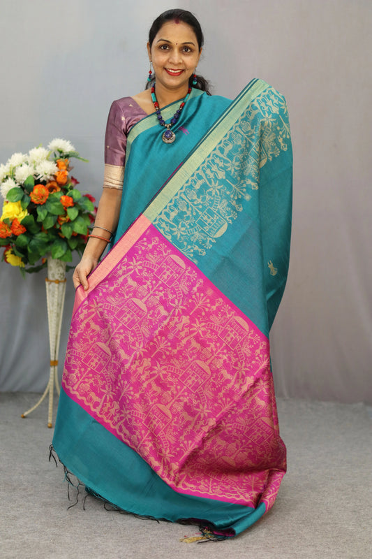 "Handcrafted saree, exuding timeless elegance in turquoise."