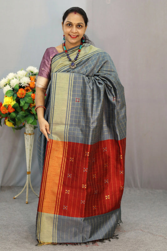 "Hand-woven saree, crafted with elegance in grey."