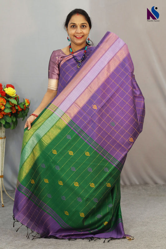 Handcrafted premium art tussar saree featuring purple body, green pallu and beautiful buta motifs