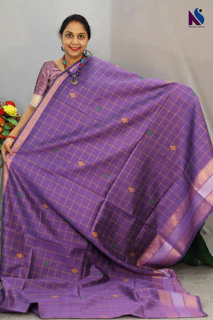 Handcrafted premium art tussar saree featuring purple body, green pallu and beautiful buta motifs