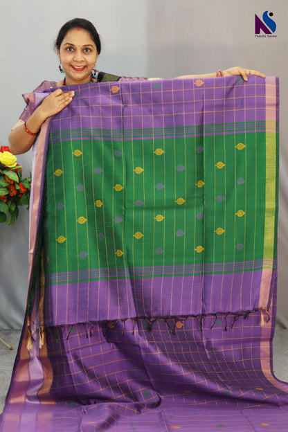 Handcrafted premium art tussar saree featuring purple body, green pallu and beautiful buta motifs