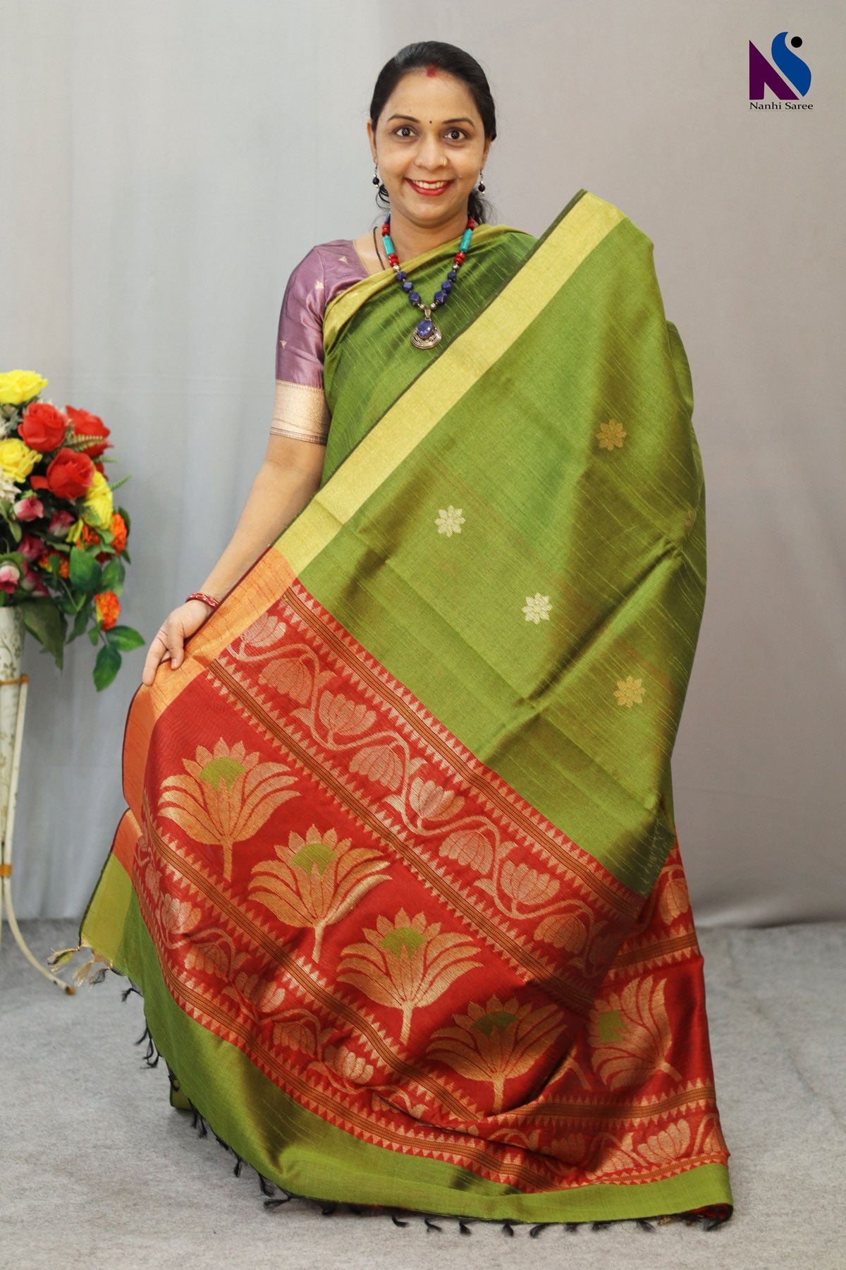 Earthy mehendi and rich red tones paired with elegant handloom craftsmanship saree