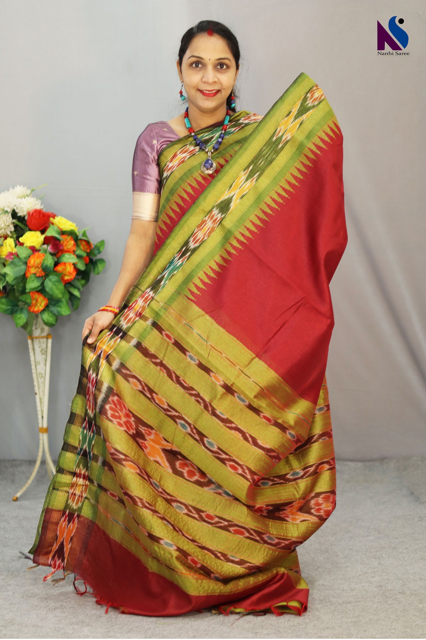 Traditional geometric patterns shine in this red Pochampally design handloom saree