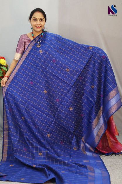 Fine buta detailing brings charm to this blue color handloom saree