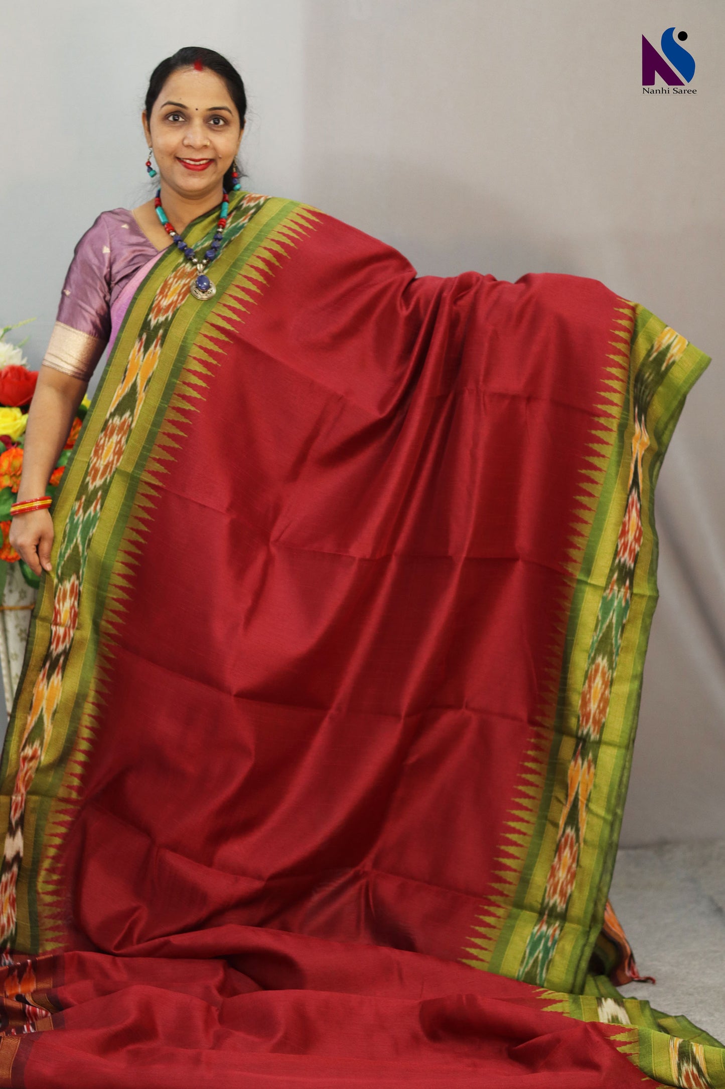 Traditional geometric patterns shine in this red Pochampally design handloom saree