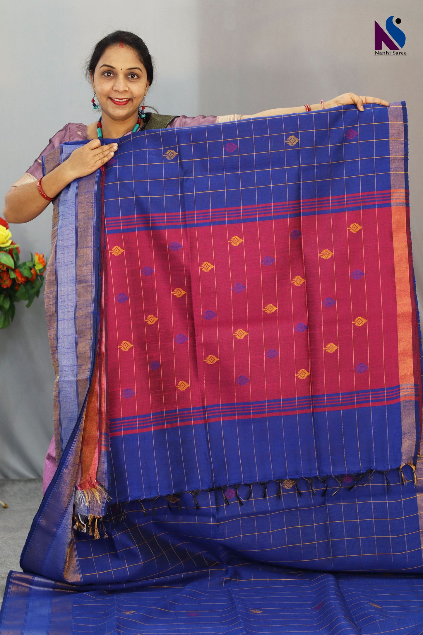 Fine buta detailing brings charm to this blue color handloom saree