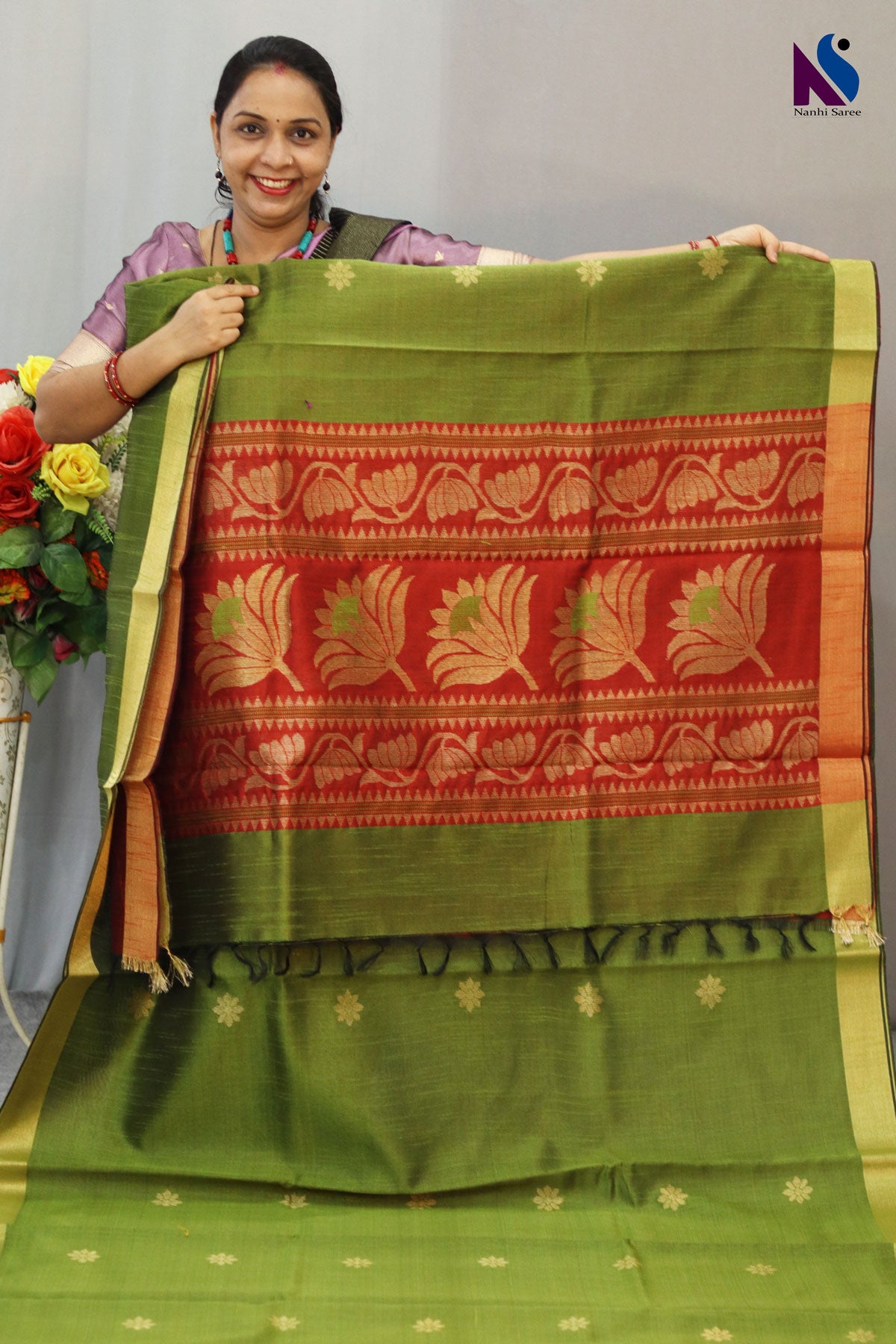 Earthy mehendi and rich red tones paired with elegant handloom craftsmanship saree