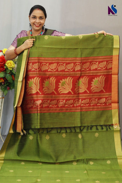 Earthy mehendi and rich red tones paired with elegant handloom craftsmanship saree