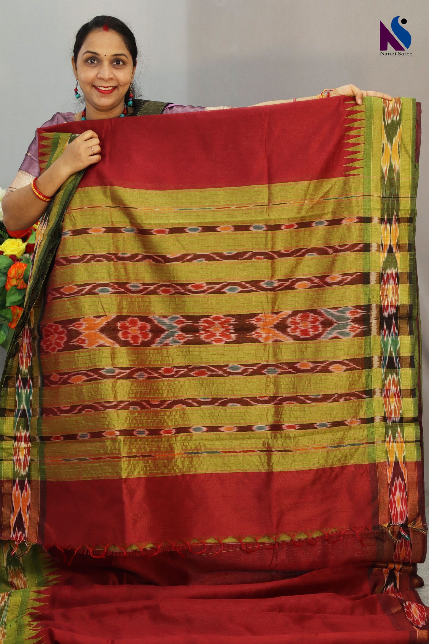 Traditional geometric patterns shine in this red Pochampally design handloom saree