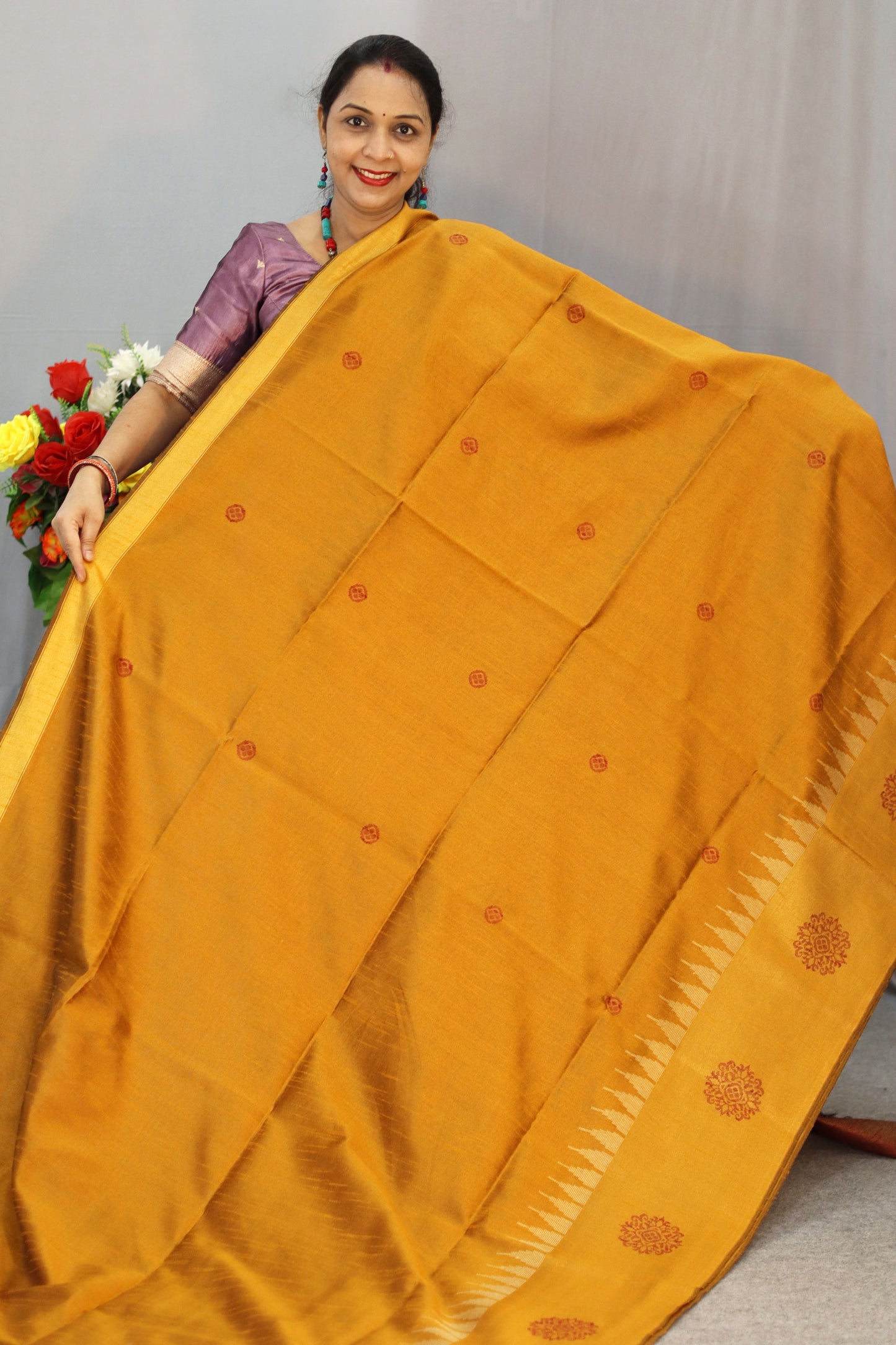 "Elegant orange and turmeric yellow hand-woven saree, crafted beautifully."