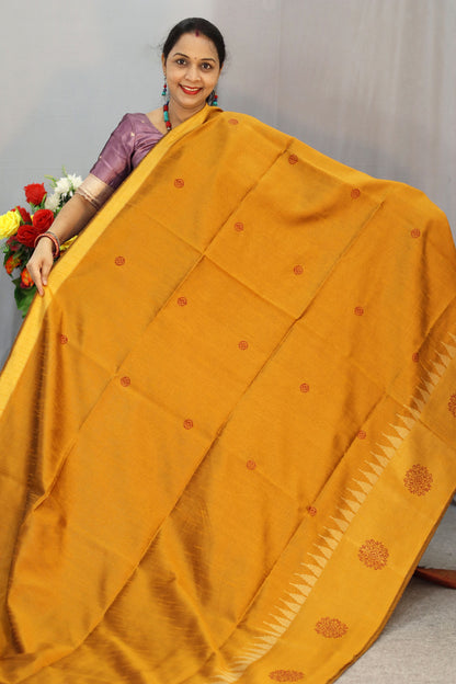 "Elegant orange and turmeric yellow hand-woven saree, crafted beautifully."
