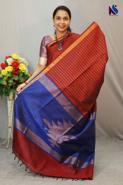 A luxurious wine red and blue pallu handloom creation with classic woven charm