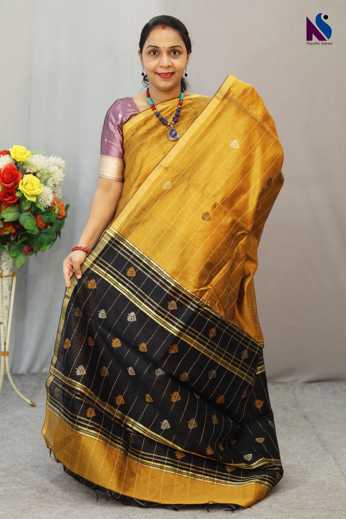 Royal fusion of golden and black crafted in premium handloom saree