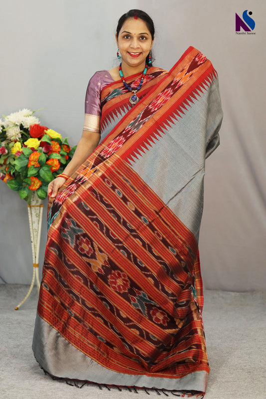 Traditional Pochampally design highlighted on this elegant grey handloom saree