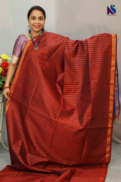 A luxurious wine red and blue pallu handloom creation with classic woven charm