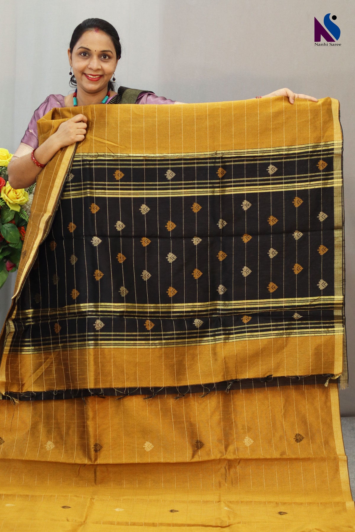 Royal fusion of golden and black crafted in premium handloom saree
