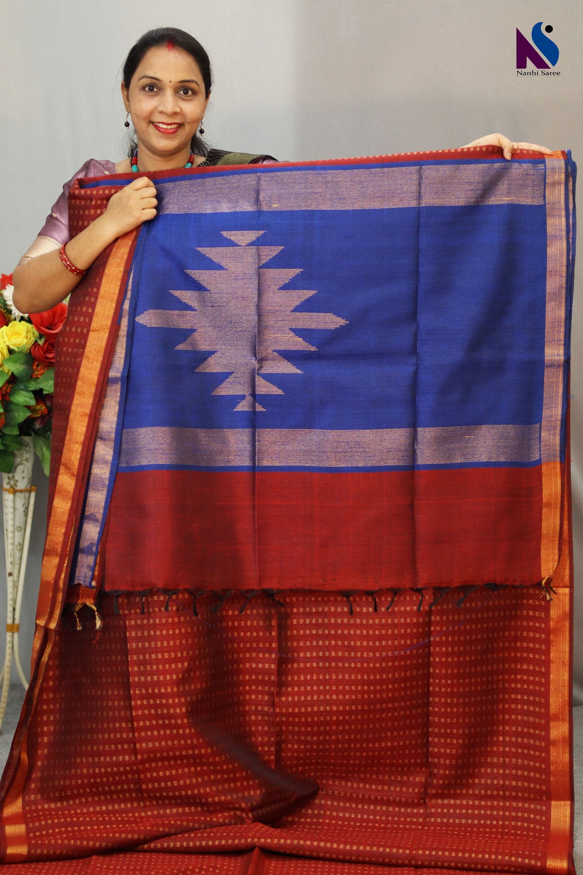 A luxurious wine red and blue pallu handloom creation with classic woven charm