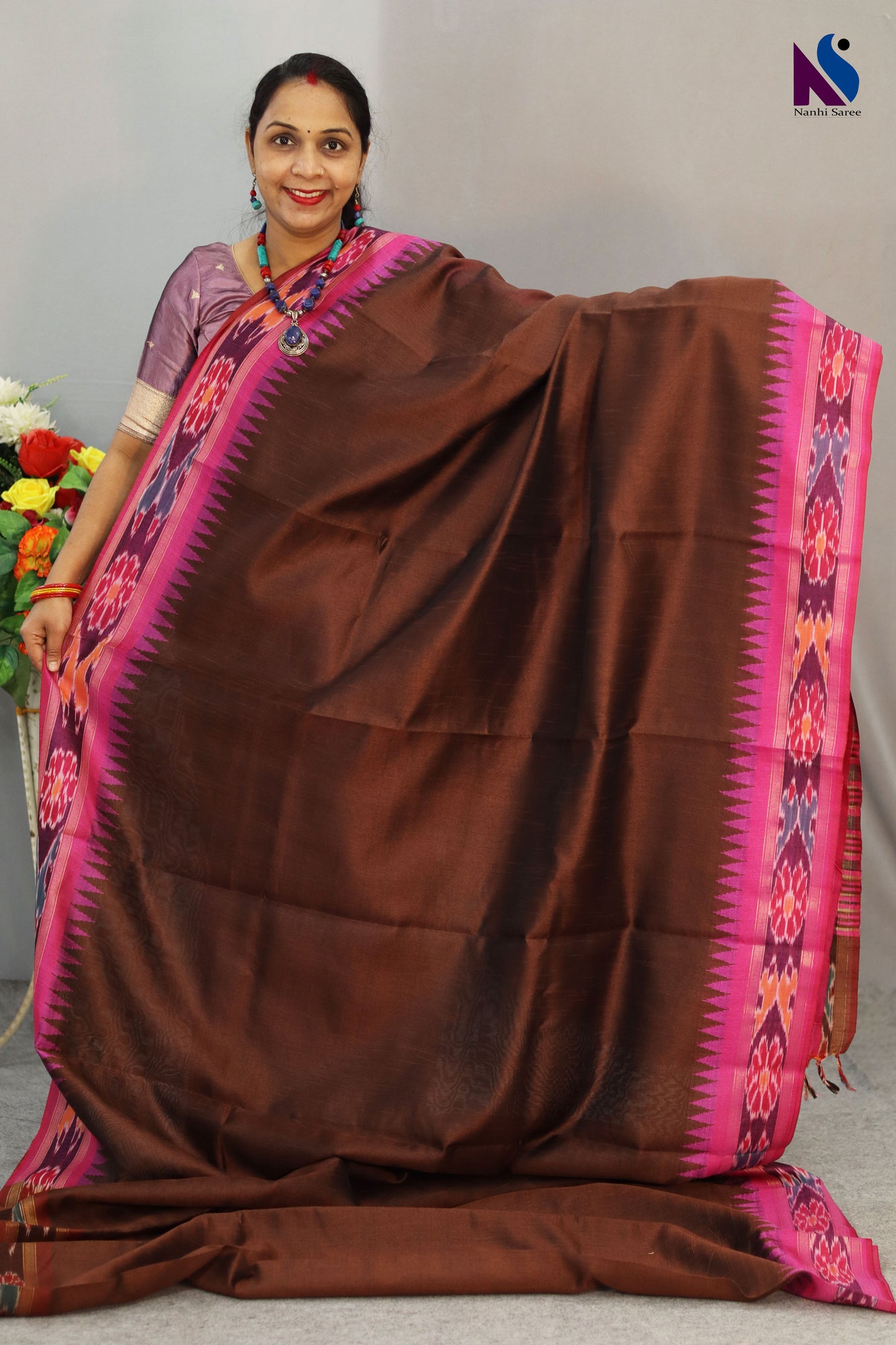Warm brown hues blended with iconic Pochampally design handloom saree