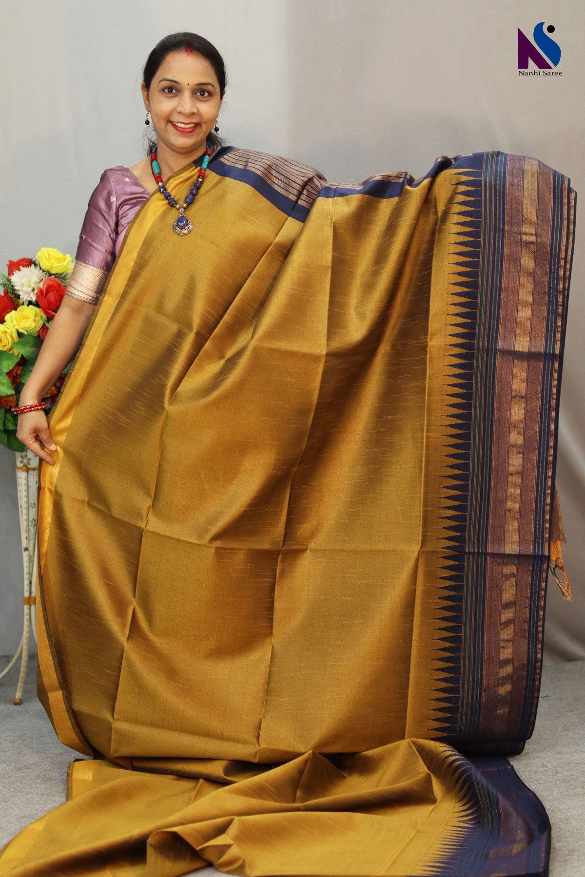 Earthy mustard tones woven in a graceful traditional handloom drape