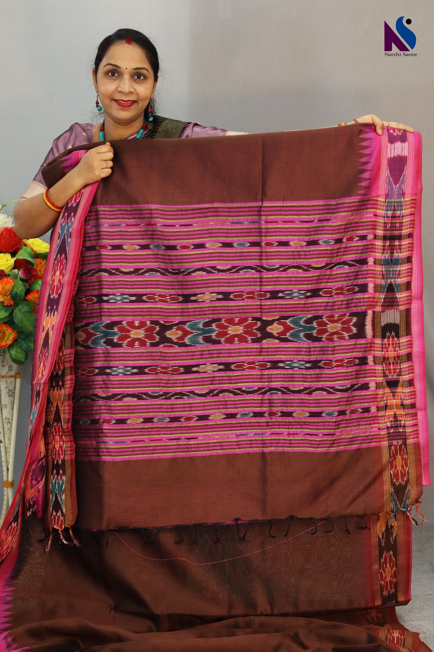 Warm brown hues blended with iconic Pochampally design handloom saree