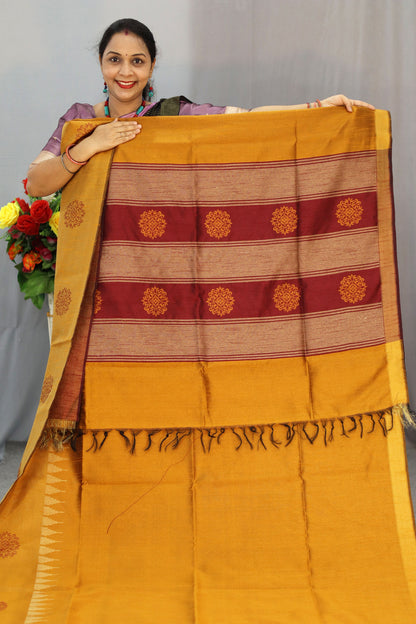 "Elegant orange and turmeric yellow hand-woven saree, crafted beautifully."
