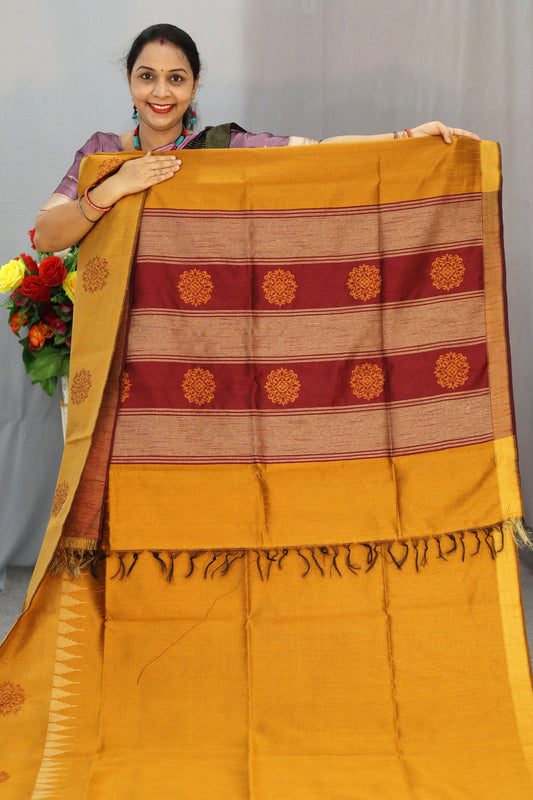 "Elegant orange and turmeric yellow hand-woven saree, crafted beautifully."