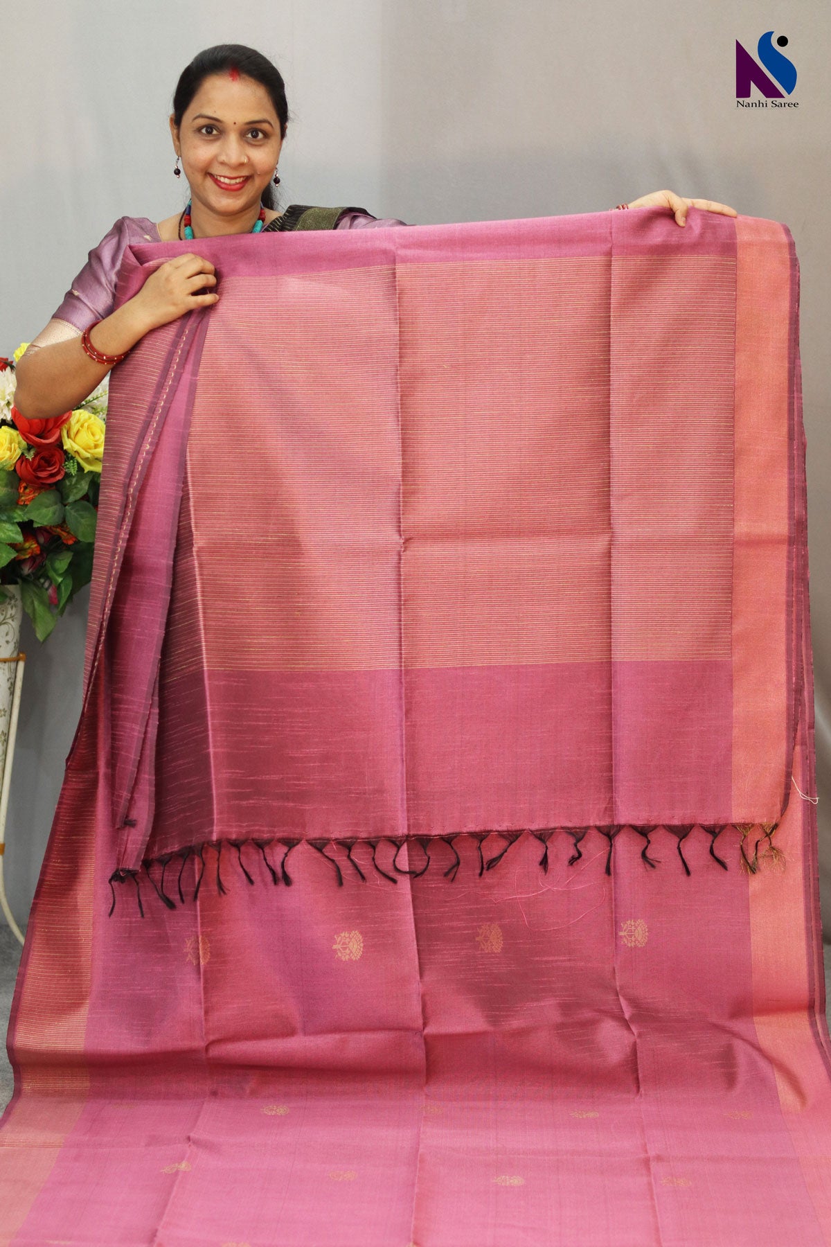 Delicate light pink tone enhanced with intricate handwoven detailing saree