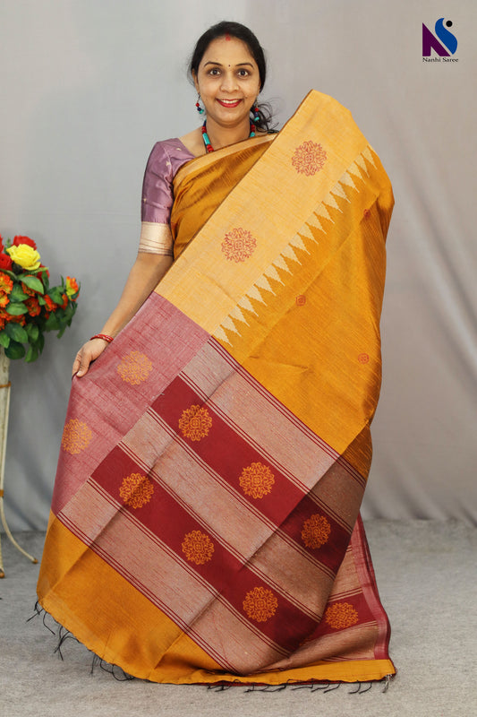 Bright turmeric yellow handloom saree showcasing elegant craftsmanship