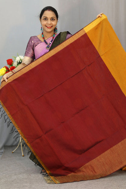 "Elegant orange and turmeric yellow hand-woven saree, crafted beautifully."
