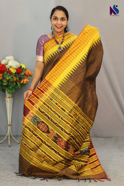 Heritage-inspired yellow Pochampally patterns adorn this elegant light brown handloom saree