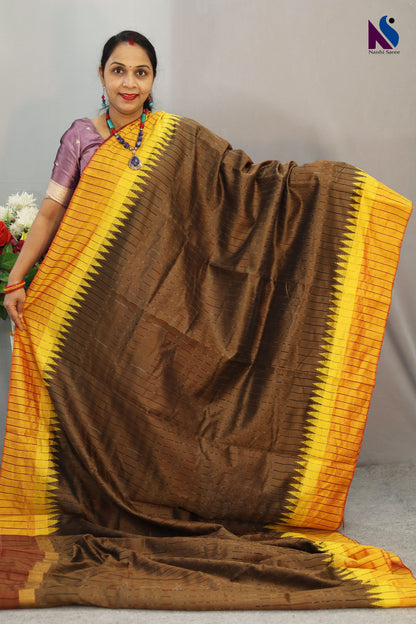 Heritage-inspired yellow Pochampally patterns adorn this elegant light brown handloom saree