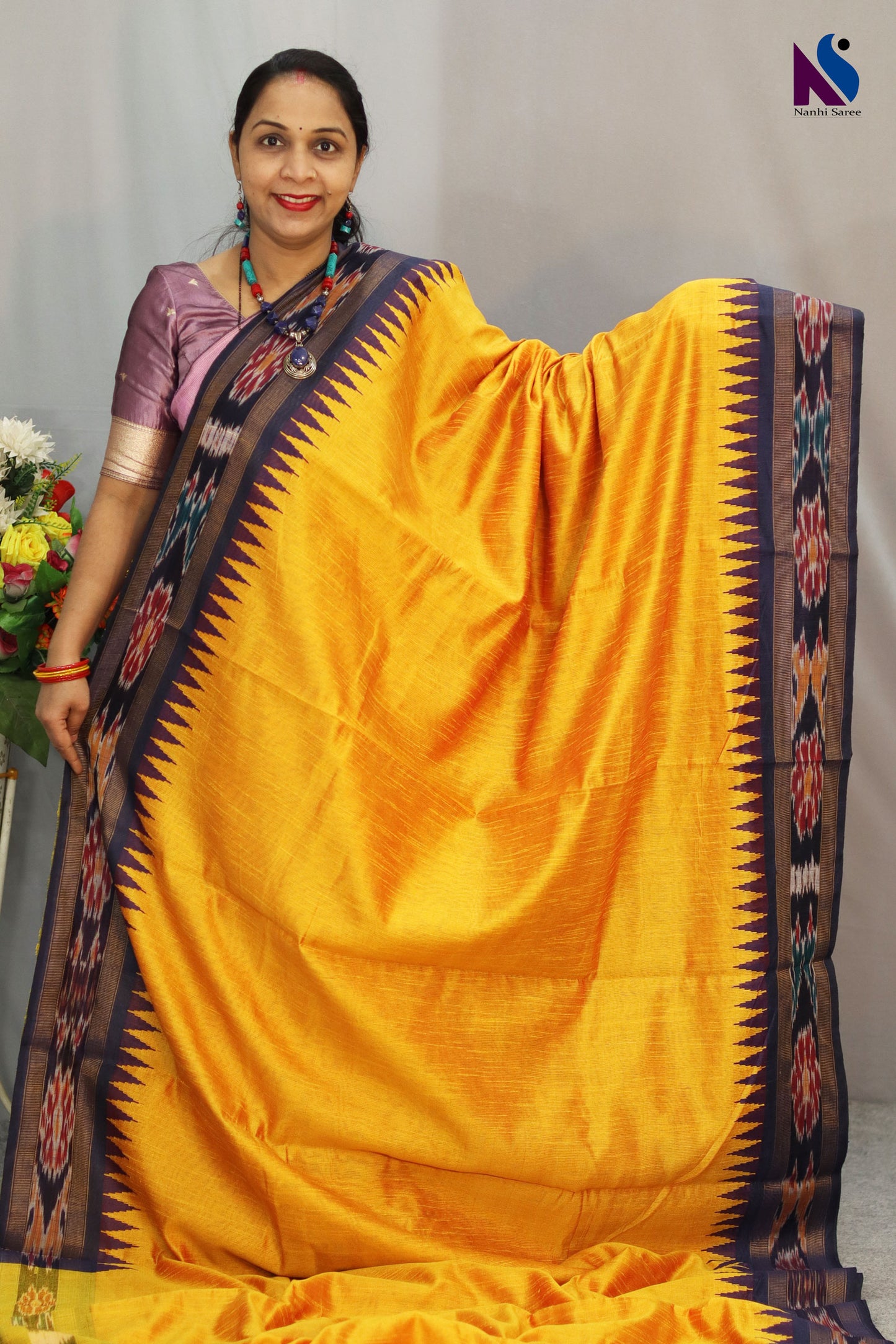 Vibrant rich yellow tones highlight the Pochampally handloom saree beautifully