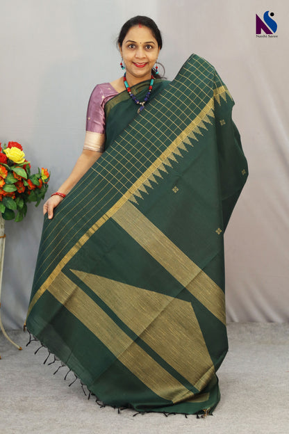 Deep earthy tones Dark green color saree and traditional weave in this handloom saree