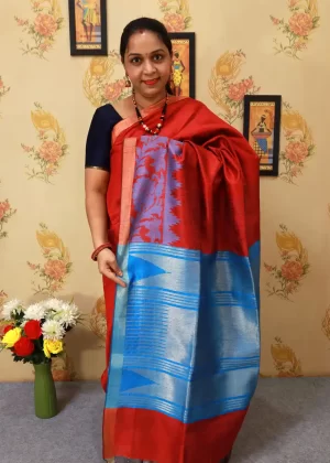 Graceful handloom saree, radiating charm in deep red."