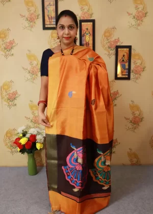 "Light orange hand-woven saree, radiating elegance and tradition."
