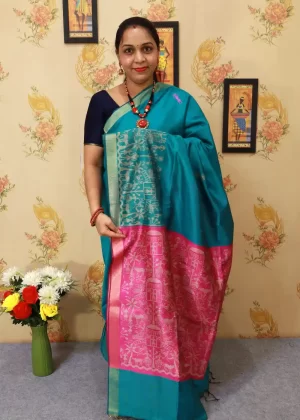"Handcrafted saree, exuding timeless elegance in turquoise."