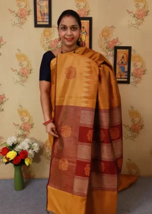 "Elegant orange and turmeric yellow hand-woven saree, crafted beautifully."