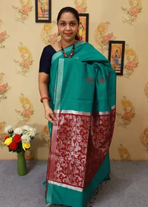 "Traditional charm meets modern style in this teal saree."