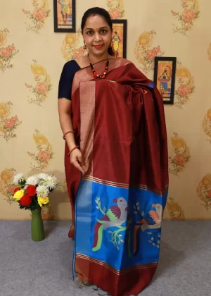"Handcrafted saree, radiating charm in deep maroon red."