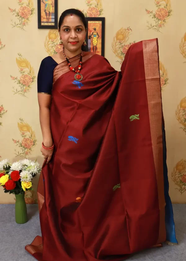 "Handcrafted saree, radiating charm in deep maroon red." - Image 2
