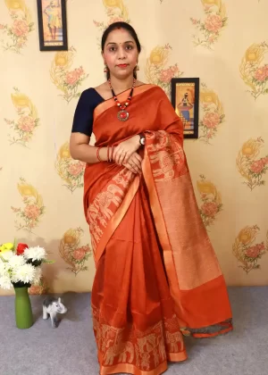 "Elegant rust orange art silk saree with timeless pallu design."